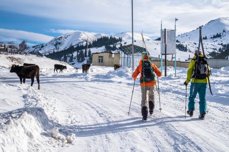 Skiers on the main street of Jyrgalan, Kyrgyzstan